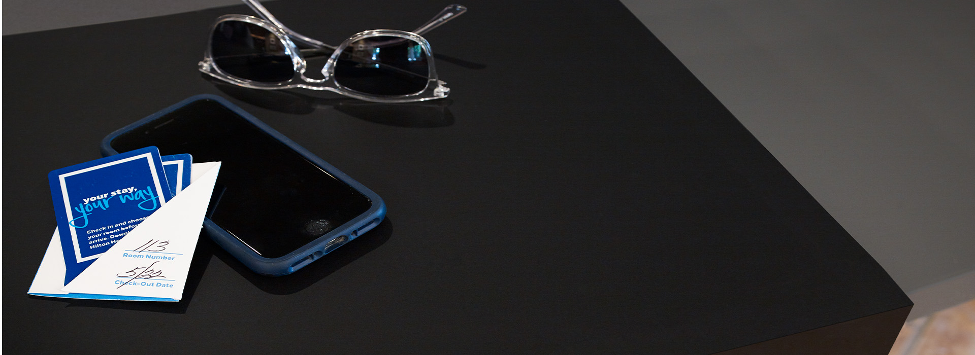 Table top with cell phone and sunglasses 909 Black Formica Infiniti ColorCore2